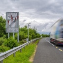 (220614) -- BELFAST, June 14, 2022 (Xinhua) -- A vehicle moves past a border sign near Newry, Northern Ireland, the United Kingdom, on June 14, 2022. The United Kingdom (UK) on Monday introduced a bill to change parts of the Northern Ireland Protocol, a post-Brexit trade deal, while the European Union (EU) said unilateral action is damaging to mutual trust and threatened legal action. TO GO WITH "Roundup: UK reveals plan to change N. Ireland Protocol as EU threatens legal action " (Photo by Colum Lynch/Xinhua)