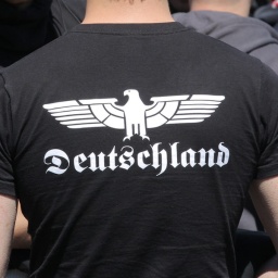 Ein Neonazi trägt ein T-Shirt mit dem Aufdruck "Deutschland" in gebrochener Schriftart.