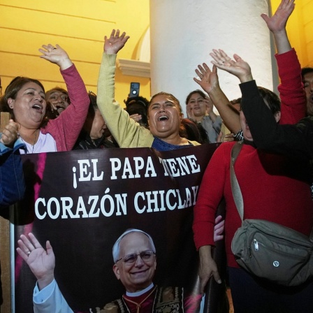 Peru, Chiclayo: Gemeindemitglieder halten ein Foto von Bischof Robert Prevost, der zum Papst Leo XIV. gewählt wurde, nach der Messe in der Kathedrale von Chiclayo, wo er mehrere Jahre lang als Bischof diente.