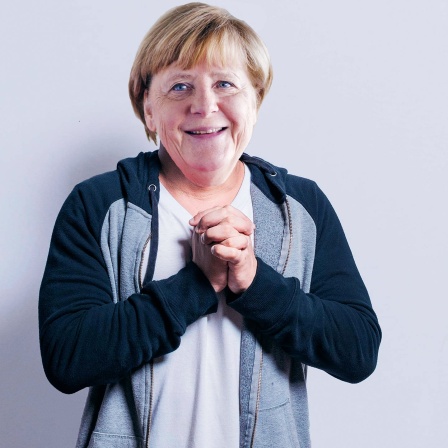 Merkel macht entschuldigende Geste