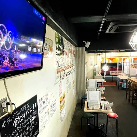 In einem Restaurant in Tokio läuft die Eröffnungszeremonie der Olympischen Spiele im Fernsehen.