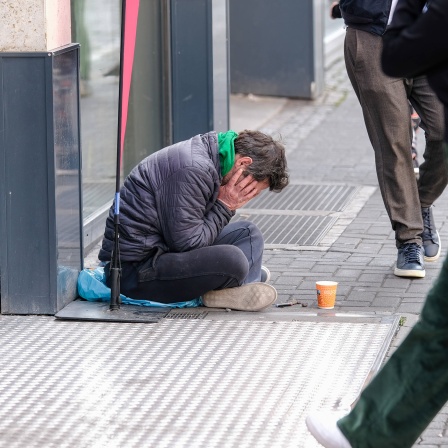 Obdachloser vor einer Bankfiliale