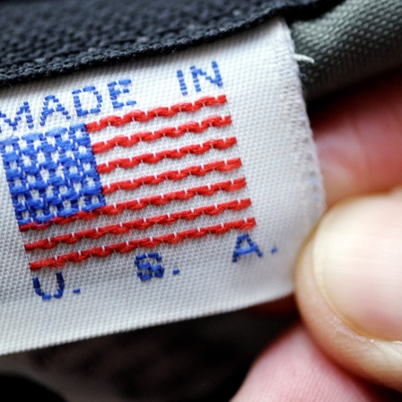 Eine Hand hält ein Etikett mit der Aufschrift &#034;Made in U.S.A.&#034;