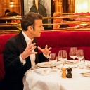 Emmanuel Macron (l.), Präsident von Frankreich, und Bundeskanzler Olaf Scholz (SPD) sitzen bei einem Essen zusammen an einem Tisch in einem Restaurant.