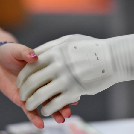 Eine Schülerin greift auf der Ideen Expo nach der künstlichen Hand eines Roboters, aufgenommen am 18.06.2019 in Hannover. Die IdeenExpo ist eine alle zwei Jahre stattfindende Mitmach- und Erlebnisveranstaltung für Kinder, Jugendliche und junge Erwachsen. Ziel ist es durch die Präsentation von innovativen Exponaten junge Menschen für Naturwissenschaften und Technik begeistern. Foto: Frank May/picture alliance