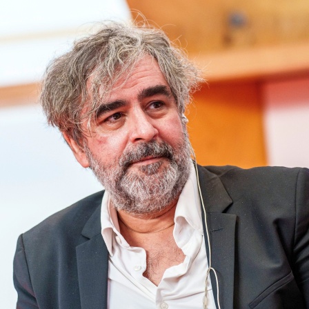 Deniz Yücel, Journalist, blickt zu einem Gesprächspartner.