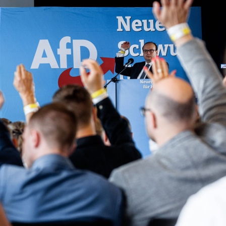 AfD-Parteimitglieder stimmen auf der Aufstellungsversammlung ihrer Partei für die Landesliste zur Bürgerschaftswahl über einen Antrag ab.