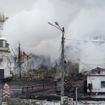 Rettungsteams bei einem zerstörten Haus in der Ukraine nach einem Luftangriff