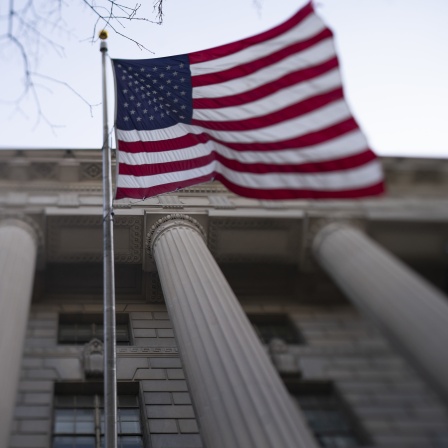 Eine amerikanische Flagge weht vor dem Besucherzentrum des Weißen Hauses. 