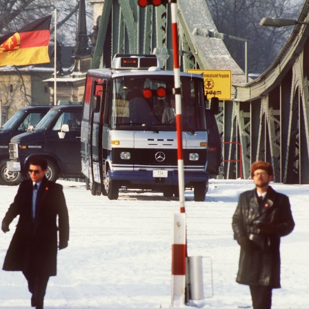 Sicherheitsbeamte in Zivil bei einem Agentenaustausch von acht Personen auf der Glienicker Brücke, die West-Berlin mit dem damaligen DDR-Bezirk Potsdam verbindet