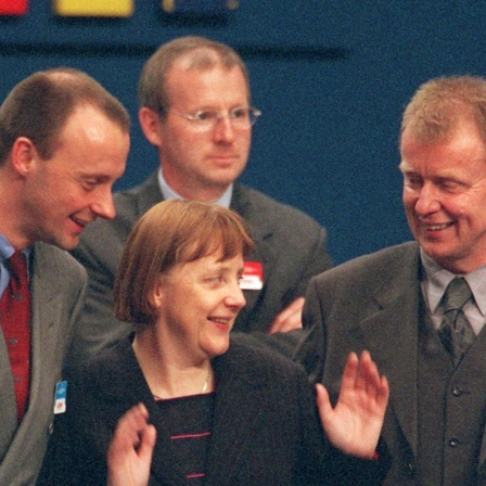 Der CDU-Fraktionvorsitzende Friedrich Merz (links) und der neue Generalssekretär Ruprecht Polenz (rechts) unterhalten sich auf dem CDU-Parteitag am 10.4.2000 in Essen mit CDU-Chefin Angela Merkel. Die 45-Jährige wurde als erste Frau zur Vorsitzenden ge