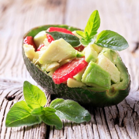 Avocado-Erdbeer-Salat in einer Avocado-Hälfte: Wie umweltschonend ist unser Essen tatsächlich hergestellt?
