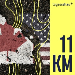 Auf dem Bürgersteig sind die Flaggen Kanadas und der Vereinigten Staaten abgebildet.