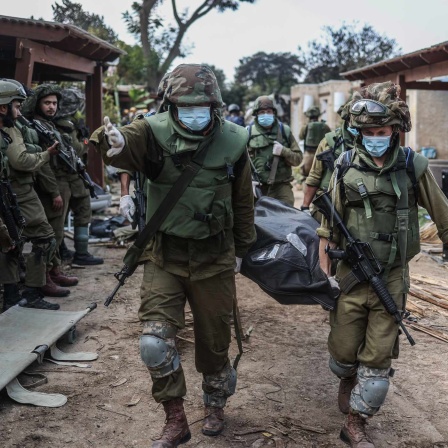 Israelische Truppen bergen Leichen aus einem zerstörten Gebäude.