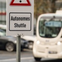 Ein Bus, davor ein Schild "Atonomes Shuttle".