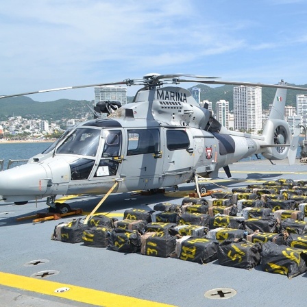 Ein Helikopter der mexikanischen Marine mit ca. 50 Kokain-Paketen davor.
