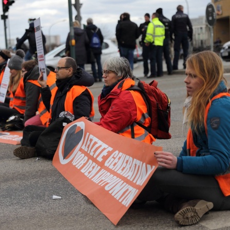 Klimaaktivisten der Gruppierung Letzte Generation blockieren mit angeklebten Händen den Straßenverkehr auf der Langen Brücke und fordern die Einberufung eines Gesellschaftsrates, Potsdam