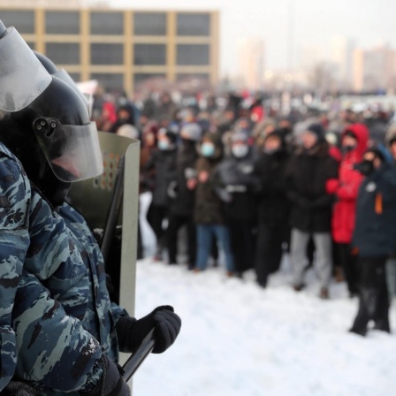 YEKATERINBURG, RUSSIA - JANUARY 23, 2021: Riot police officers and participants in an unauthorized rally in support of Russian opposition activist Alexei Navalny in Oktyabrskaya Square. Donat Sorokin
