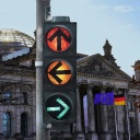 Deutscher Bundestag mit Ampel und Pfeilen in unterschiedliche Richtungen (Fotomontage)