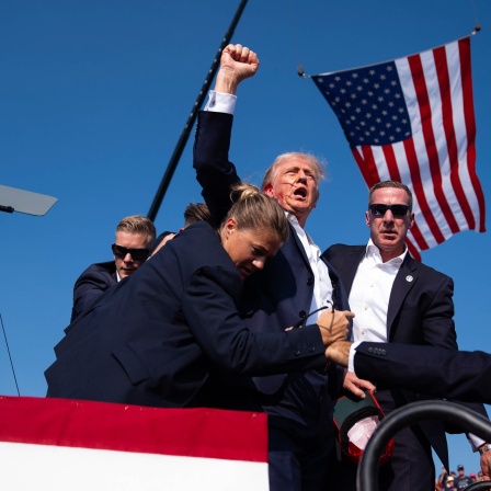 Republican presidential candidate former President Donald Trump is surrounded by U.S. Secret Service agents at a campaign rally, Saturday, July 13, 2024, in Butler, Pa. (AP Photo/Evan Vucci)