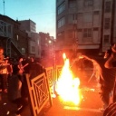 In this Wednesday, Sept. 21, 2022, photo taken by an individual not employed by the Associated Press and obtained by the AP outside Iran, protesters make fire and block the street during a protest over the death of a woman who was detained by the morality police, in downtown Tehran, Iran.