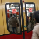Rote Schilder weisen auf der S-Bahn Tür auf die Pflicht zum Tragen einer Maske hin.
