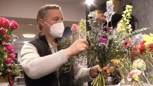 Ein Mann bindet einen Blumestrauß | Bild: Bayerischer Rundfunk 2021