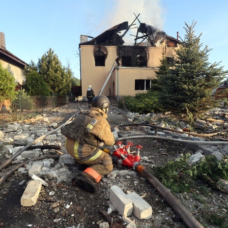 Nach einem russischen Raketenangriff in Charkiw im Nordosten der Ukraine sind Rettungskräfte bei der Arbeit in einem Haus zu sehen.
