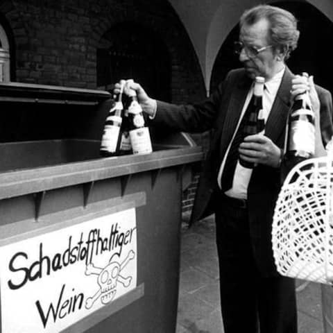 Zwei Krefelder Bürger bringen am 31. Juli 1985 Flaschen mit gepanschtem Wein zu einem eigens dafür aufgestellten Container.