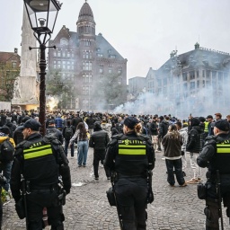 Sicherheitskräfte ergreifen Maßnahmen, während Fans von Maccabi Tel Aviv am Dam-Platz eine pro-israelische Demonstration veranstalten, bei der sie vor dem UEFA-Europa-League-Spiel zwischen Maccabi Tel Aviv und Ajax am 7. November 2024 in Amsterdam, Niederlande, Leuchtraketen zünden und Parolen rufen.
