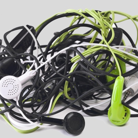 Twisted headphones, of different colors, on white background