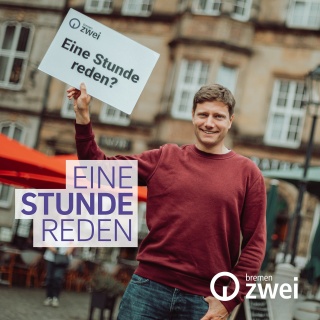 Ein Mann hält ein Schild auf dem steht: Eine Stunde reden