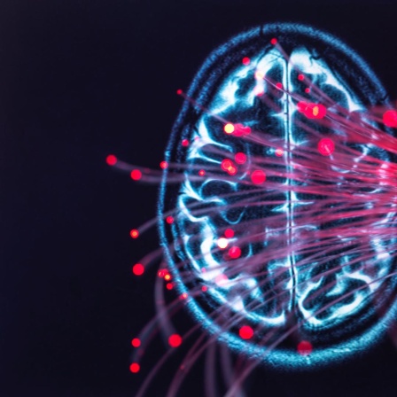 MRT-Scan eines Gehirns mit vielen roten Lichtpunkten unscharf im Bildvordergrund.