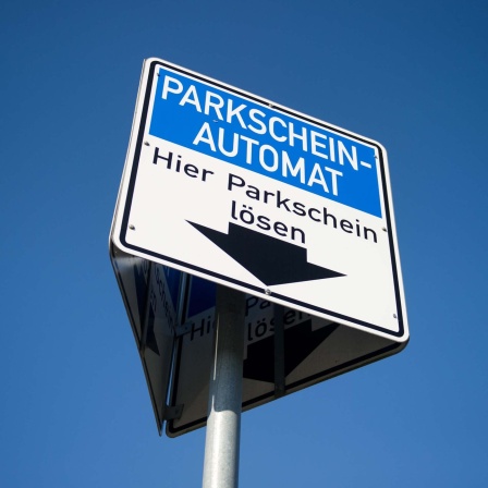 Ein Schild weist auf einen Parkscheinautomaten hin.