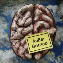 Gemaltes Bild eines Gehirns und ein Schild mit der Auschrift "Außer Betrieb"