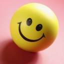 Ein lachender Smiley als Kugel auf rotem Grund