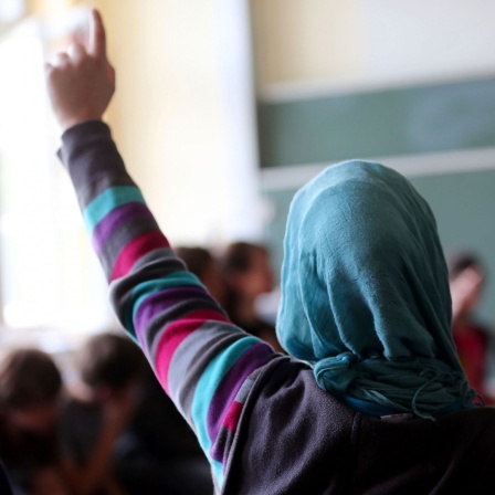 Eine Schülerin mit Kopftuch aus der Türkei meldet sich im Unterricht am 10.06.2013 in Oberhausen (Nordrhein-Westfalen) 