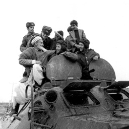 Afghanische Männer verbrüdern sich mit sowjetischen Sodlaten auf einem sowjetischen Panzer, aufgenommen in Hairhana im März 1980. 