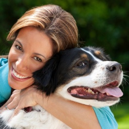 Portrait of middle aged hispanic woman and her dog in backyard Dallas Texas USA