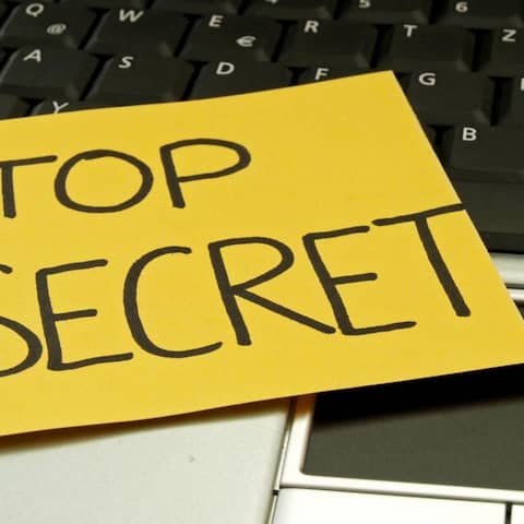 Auf einem Laptop klebt eine Notiz mit der Aufschrift "top secret"