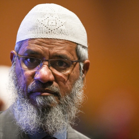 Controversial Indian Islamic preacher Zakir Naik arrives during the opening ceremony of the Kuala Lumpur Summit 2019 in Kuala Lumpur on December 19, 2019. (Photo by Mohd RASFAN / AFP)