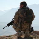 Ein Soldat mit einem Gewehr steht auf einem Berg.