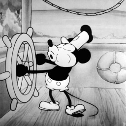 "Steamboat Willie" von 1928 war der erste veröffentlichte Trickfilm mit Comicfigur Micky Maus, hier in einer Szene am Steuerrad eines Schaufelraddampfers 