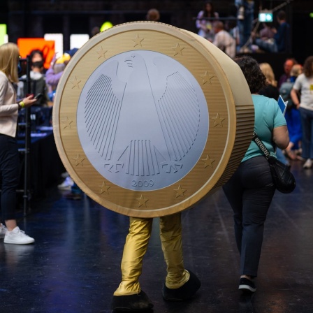 Eine Person verkleidet als eine EinEuro-Münze geht während der Digital-Konferenz
«Republica» durch eine Halle