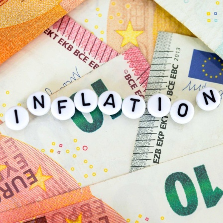 Symbolfoto Inflation Inflationsrate mit Geldscheinen und Geldmuentzen im Hintergrund