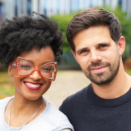 Zodwa Selele und Josef Ellers stehen dicht nebeneinander in einem Garten.