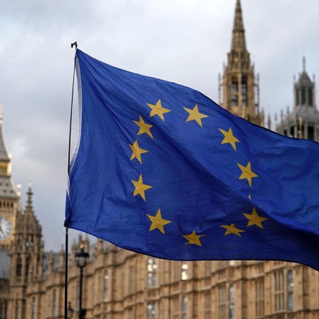 Eine Flagge der Europäischen Union weht vor den Houses of Parliament. Nach jahrelangem Streit über die Brexit-Sonderregeln für Nordirland haben Großbritannien und die EU eine Einigung erzielt.