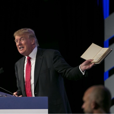 Der republikanische Präsidentschaftskandidat Donald Trump spricht, während er eine Bibel in der Hand hält. (2015)