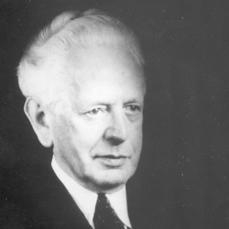 Porträt des Philosophen Ernst Cassierer vor schwarzem Hintergrund.