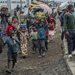 People displaced by the fighting with M23 rebels make their way to the center of Goma, Democratic Republic of the Congo, Sunday, Jan. 26, 2025. (AP Photo/Moses Sawasawa)